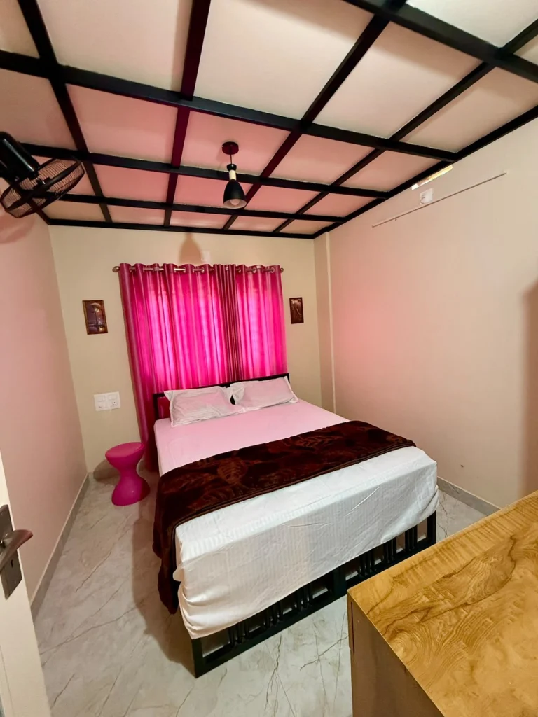 Bedroom with a double bed and pink curtains