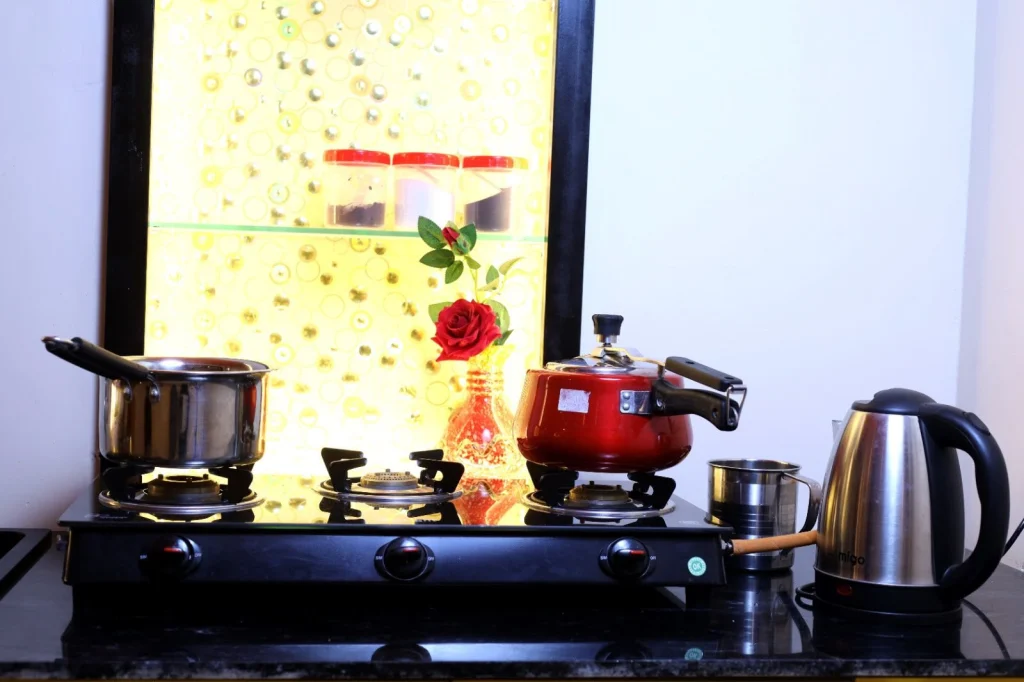 Kitchen counter with gas stove, pans and kettle